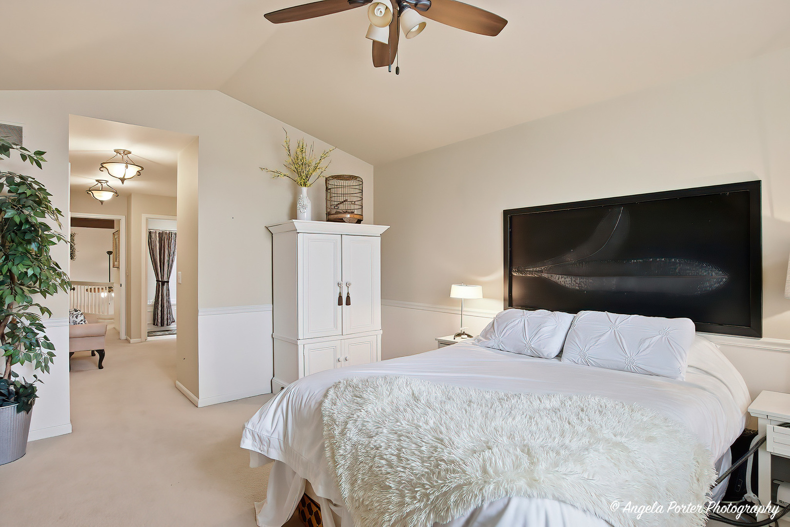 890 Shoreline Road Lake Barrington, IL 60010 - Photo 16 of 42 a bedroom with a bed and a chandelier