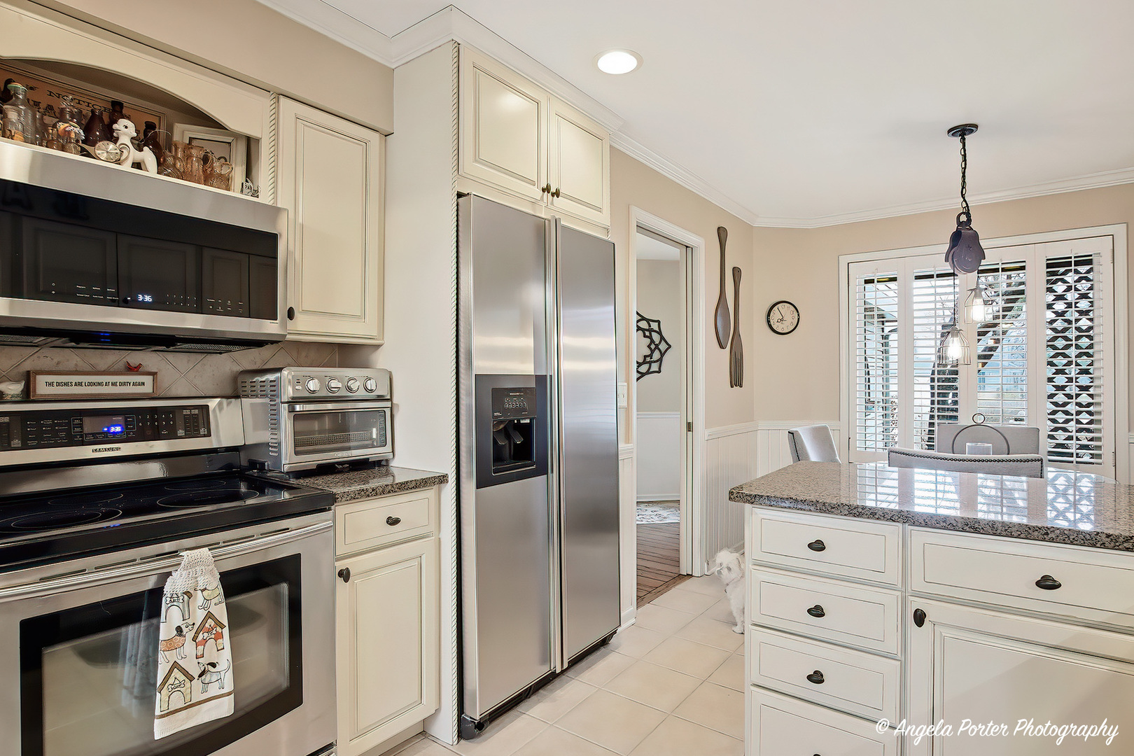 890 Shoreline Road Lake Barrington, IL 60010 - Photo 5 of 42 a kitchen with white cabinets and stainless steel appliances