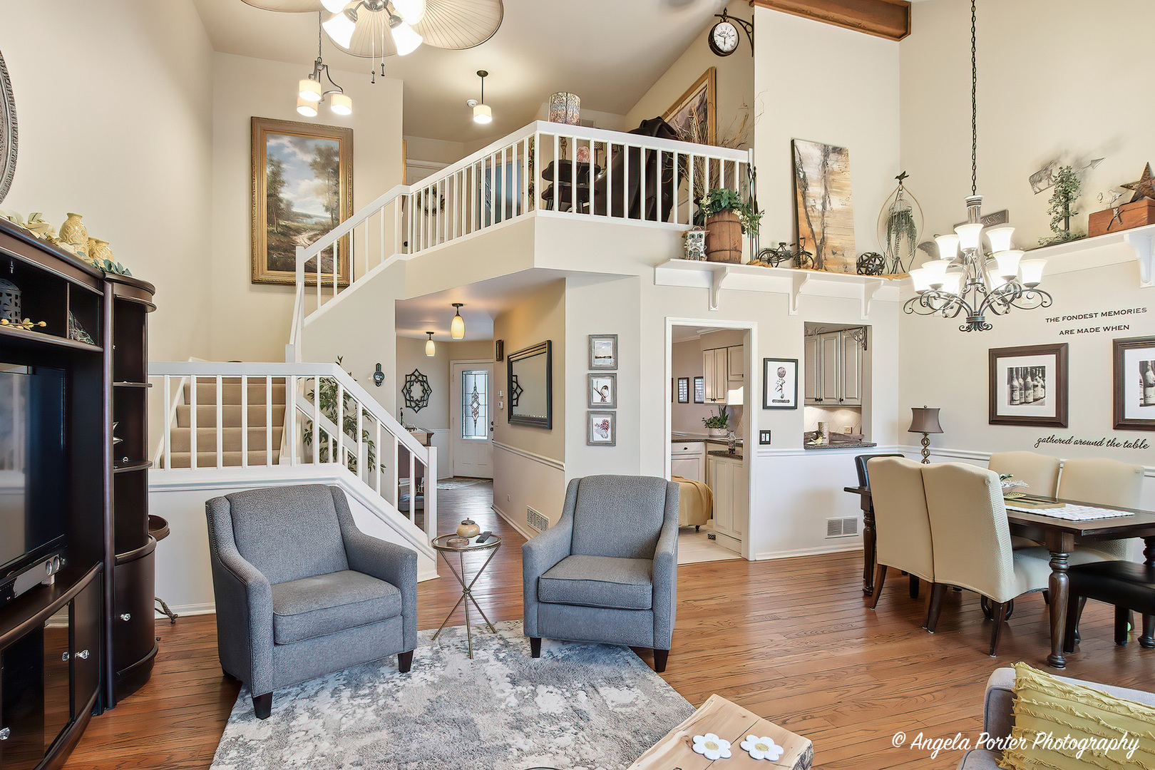 890 Shoreline Road Lake Barrington, IL 60010 - Photo 10 of 42 a living room with furniture a fireplace and a chandelier