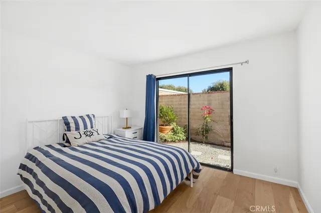 a bedroom with a large bed and a large window