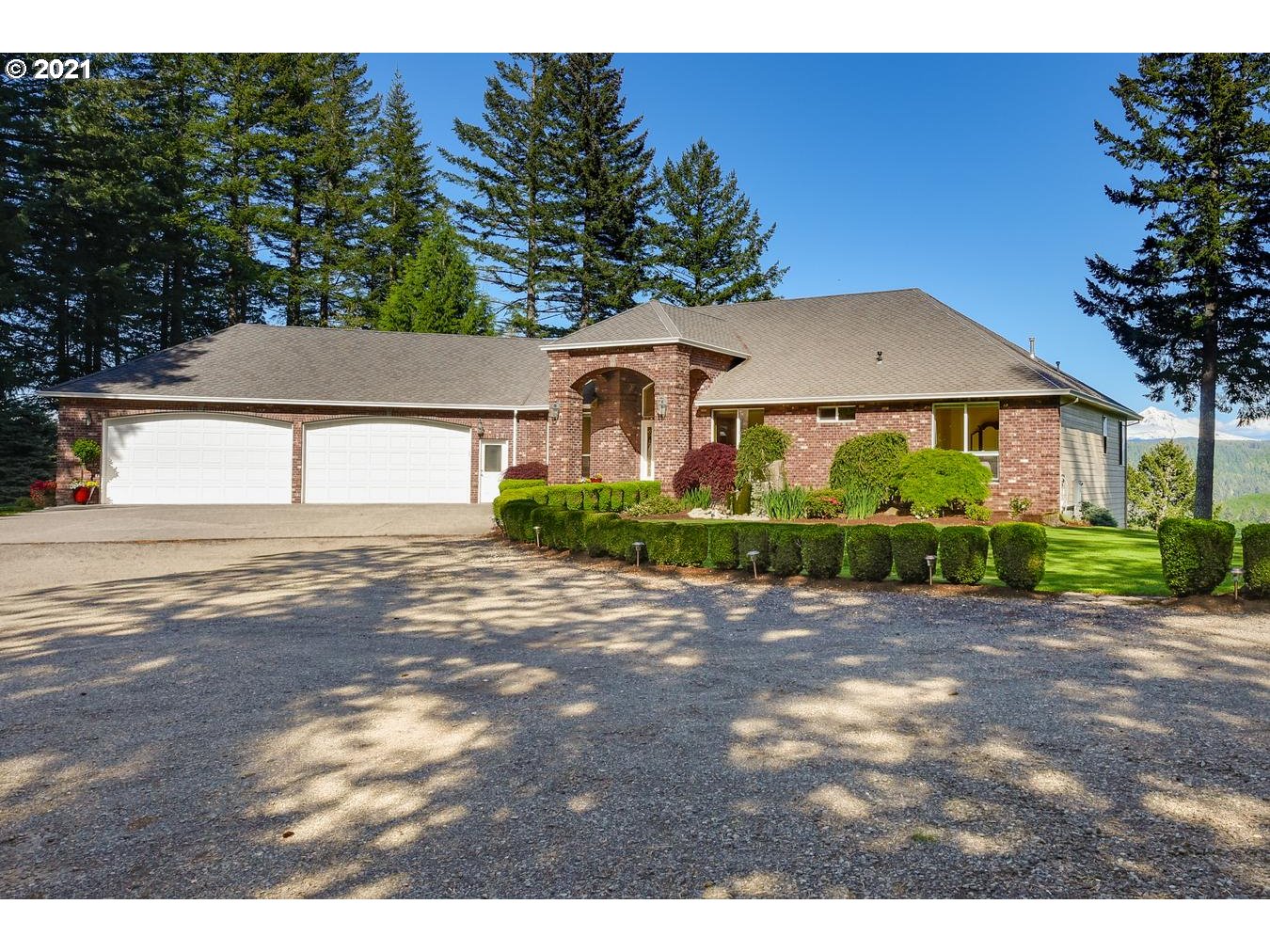 38636 Southeast Hudson Road Sandy, OR 97055 - Photo 1 of 32 a front view of a house with a garden