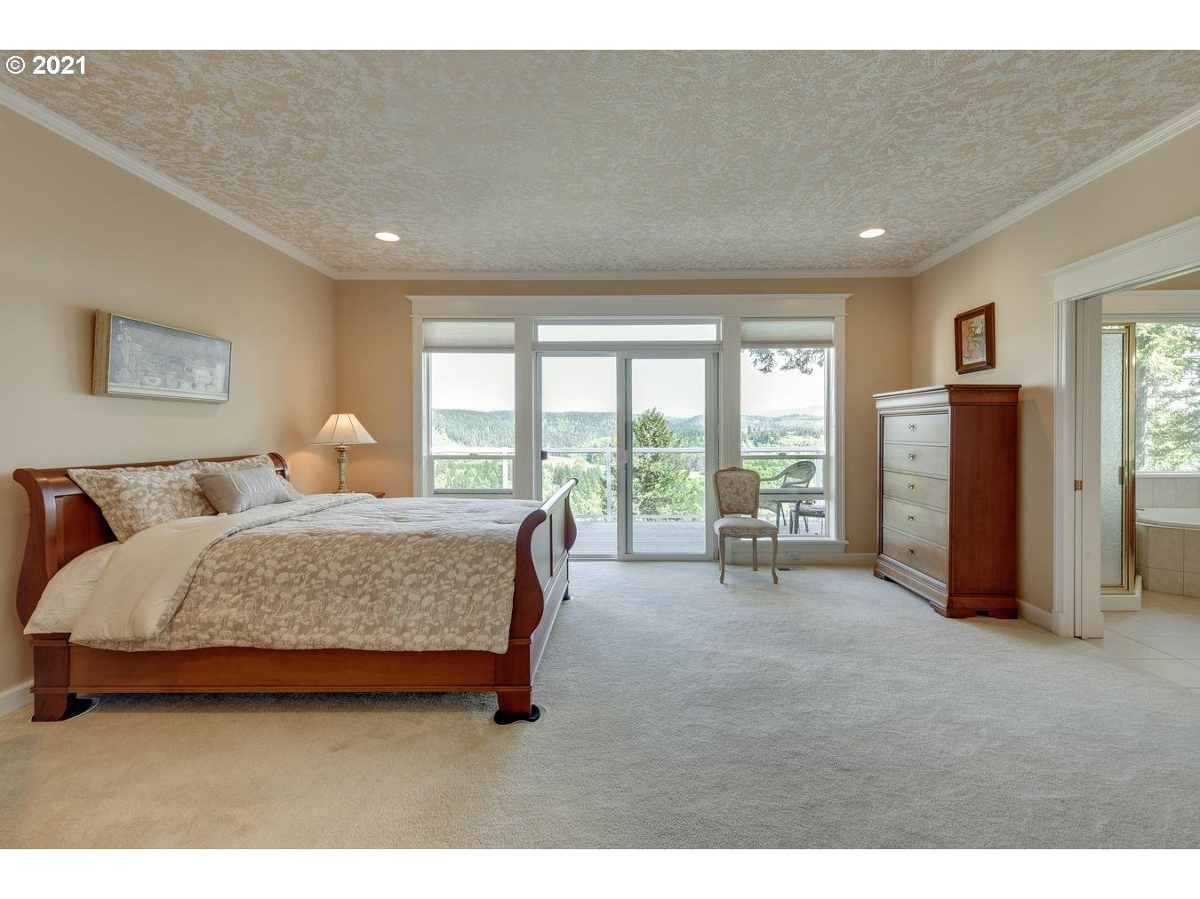 38636 Southeast Hudson Road Sandy, OR 97055 - Photo 15 of 32 a spacious bedroom with a bed and a large window