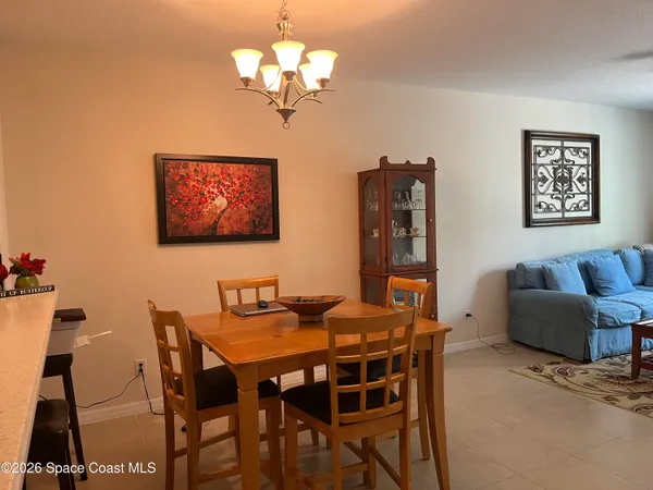a view of a dining room with furniture and chandelier