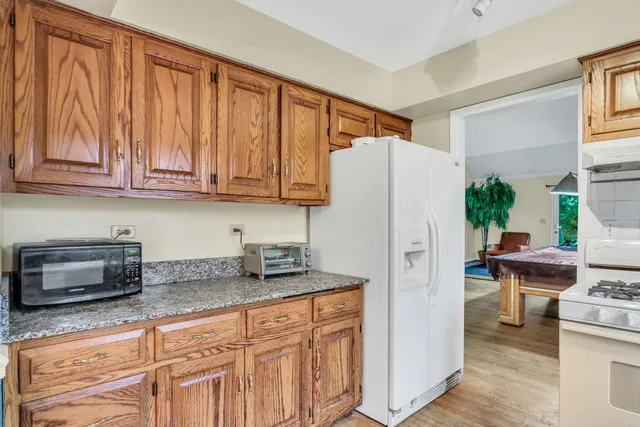 a kitchen with stainless steel appliances granite countertop a refrigerator and a sink