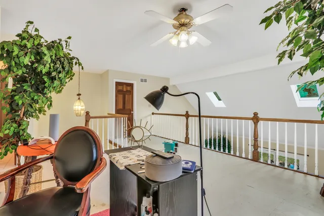a living room with furniture and a mirror