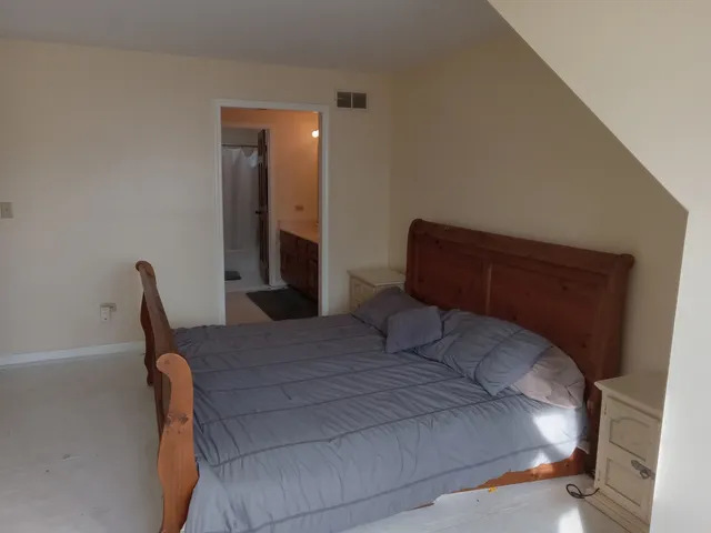 a bedroom with a bed and chair