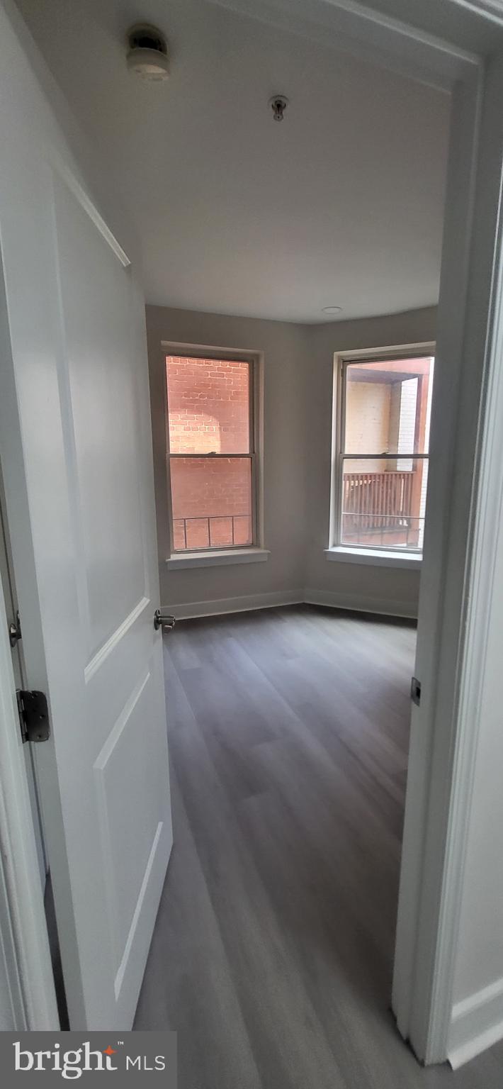 1108 Columbia Road Northwest, Unit 202 Washington, DC 20009 - Photo 14 of 19 an empty room with windows