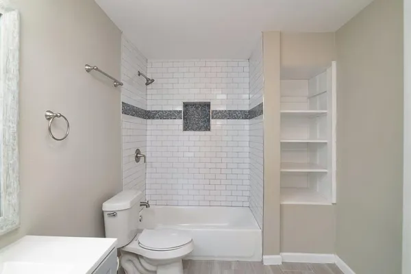 a bathroom with a toilet and a shower