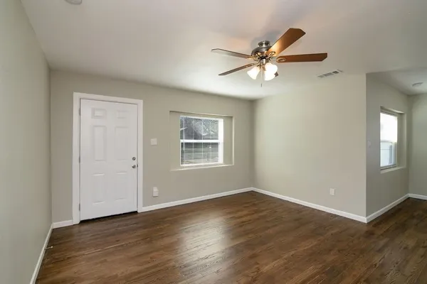 a view of a ceiling fan with wooden floor