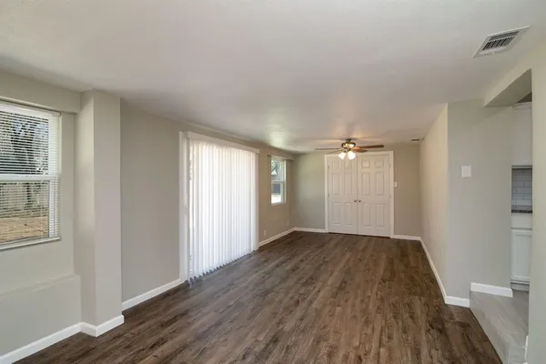 wooden floor in an empty room with a window
