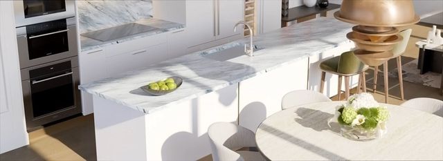 a large white tub sitting in a bathroom next to a window