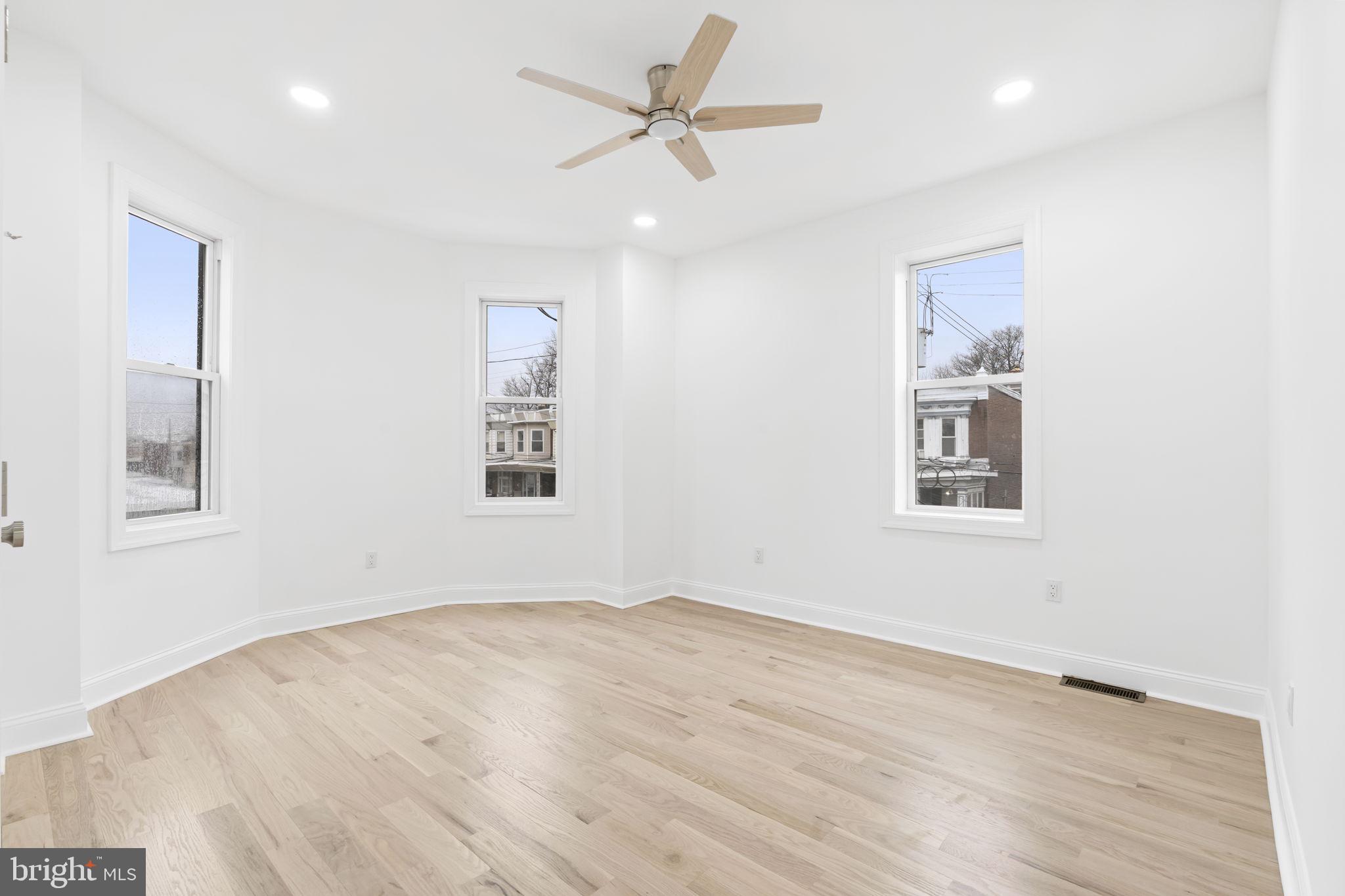 628 South 51st Street Philadelphia, PA 19143 - Photo 14 of 17 a view of a big room with wooden floor and a chandelier fan