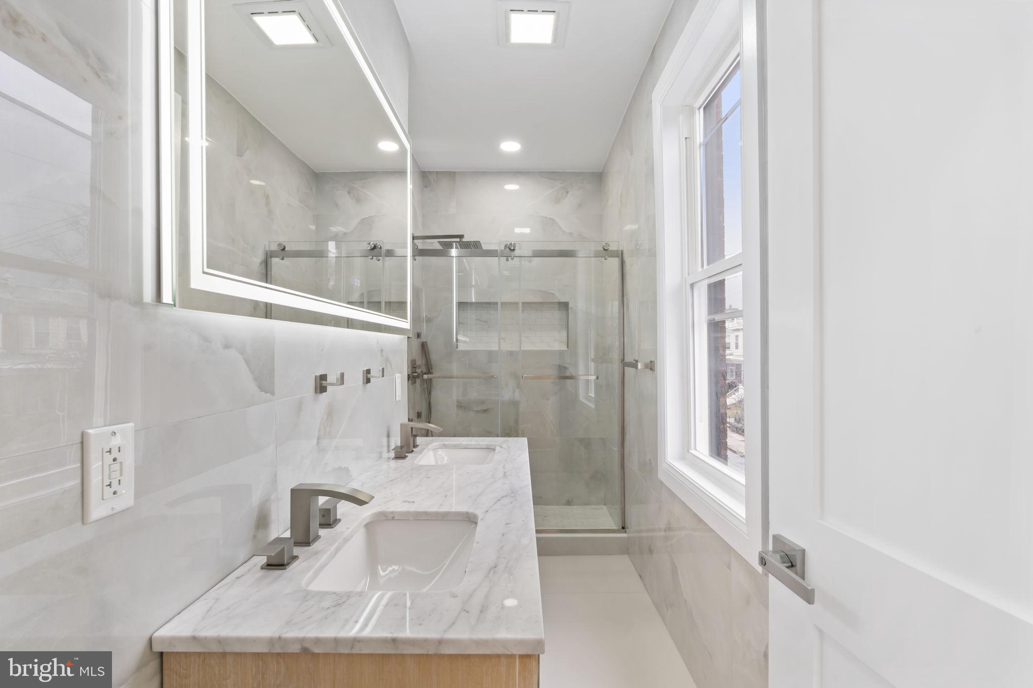 628 South 51st Street Philadelphia, PA 19143 - Photo 15 of 17 a bathroom with a sink and a mirror