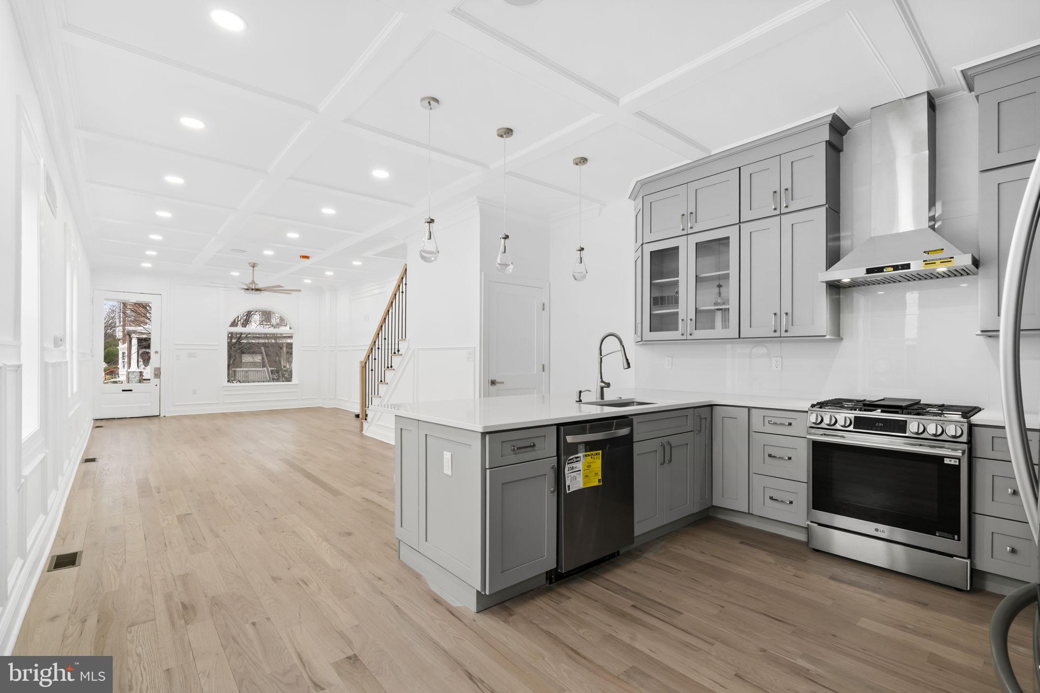 628 South 51st Street Philadelphia, PA 19143 - Photo 3 of 17 a kitchen with stainless steel appliances granite countertop a stove and a sink