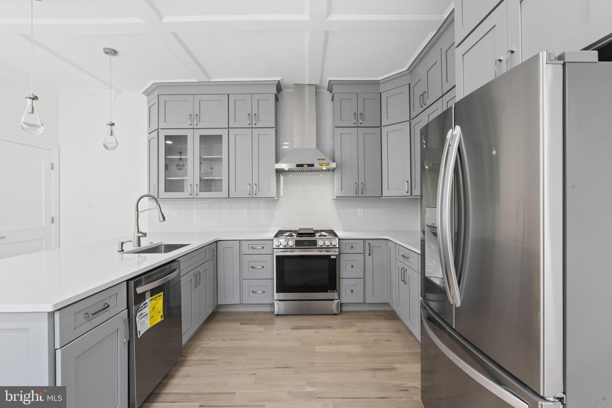 628 South 51st Street Philadelphia, PA 19143 - Photo 5 of 17 a kitchen with stainless steel appliances granite countertop a refrigerator and a stove