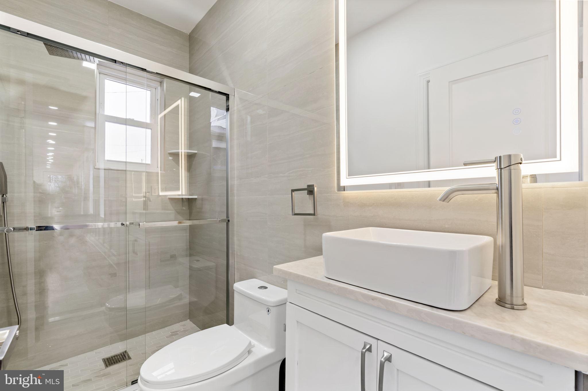 628 South 51st Street Philadelphia, PA 19143 - Photo 7 of 17 a bathroom with a sink a toilet and shower