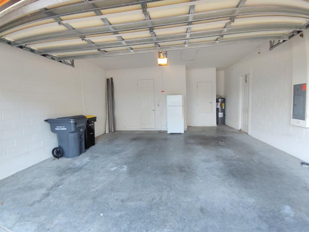 843 Glendora Road Poinciana, FL 34759 - Photo 15 of 15 a view of a garage with furniture