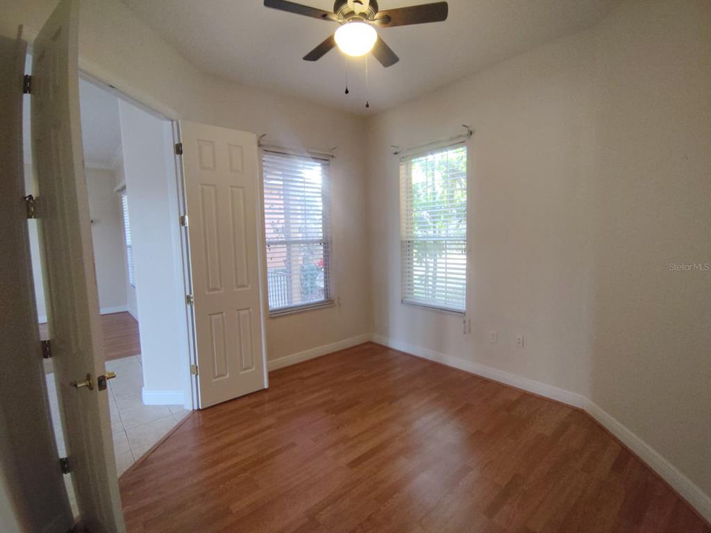 843 Glendora Road Poinciana, FL 34759 - Photo 2 of 15 wooden floor in an empty room with a window
