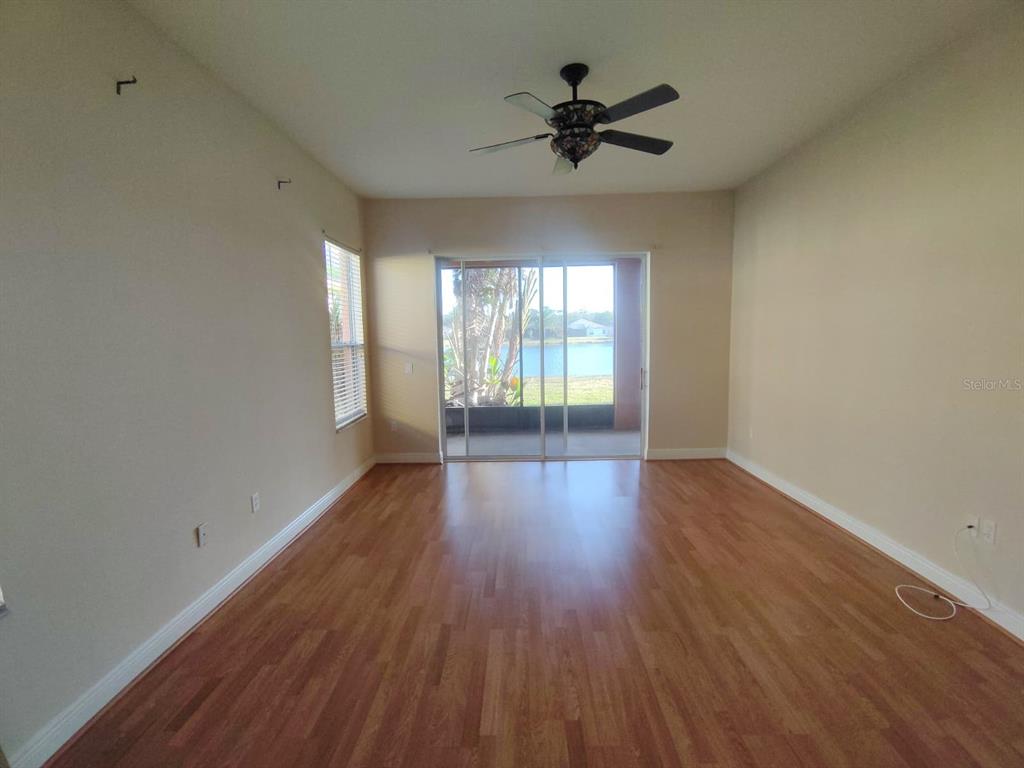 843 Glendora Road Poinciana, FL 34759 - Photo 9 of 15 a view of empty room with wooden floor and fan