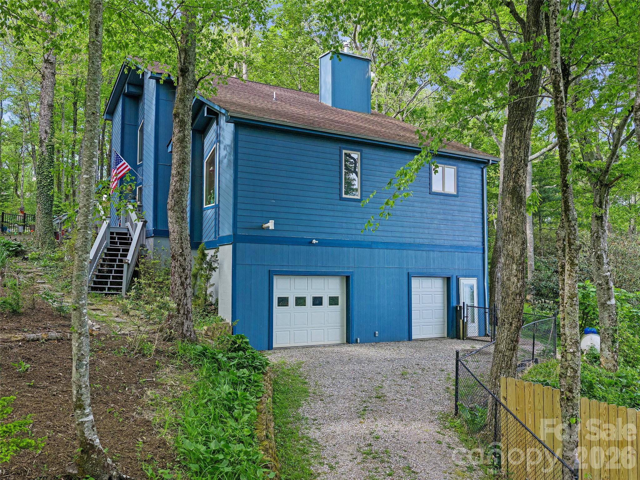 228 Continental Divide Road Spruce Pine, NC 28777 - Photo 33 of 48 a front view of a house with a garden