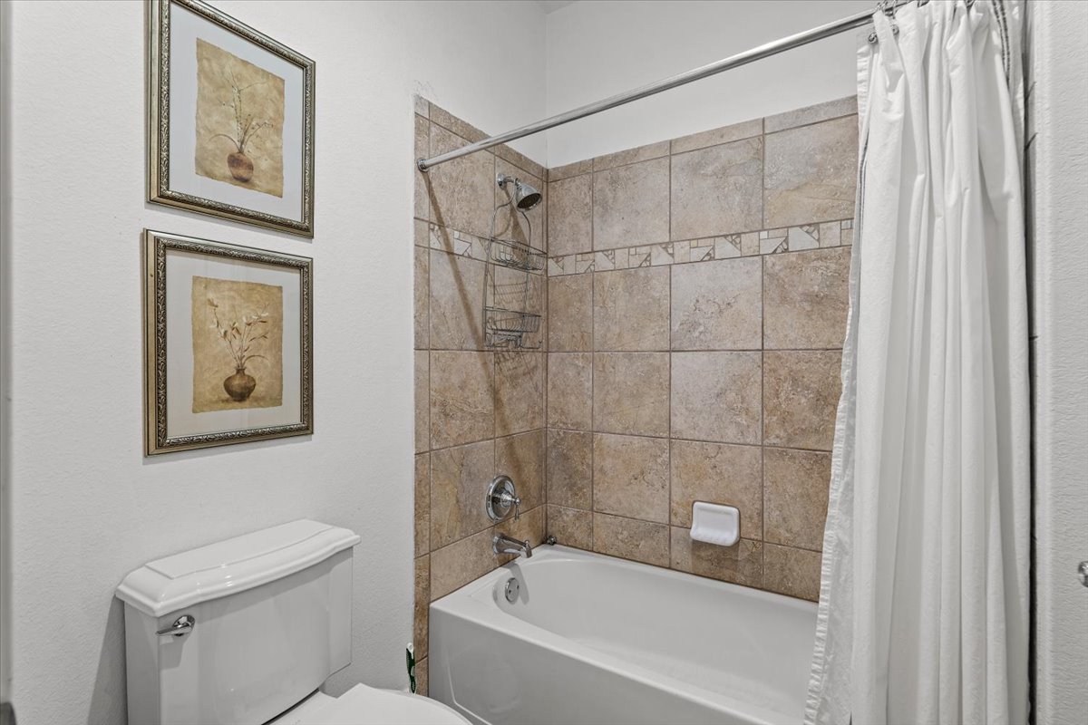 503 Breezeway Lane Georgetown, TX 78633 - Photo 30 of 38 A well-appointed bath features a tiled shower.