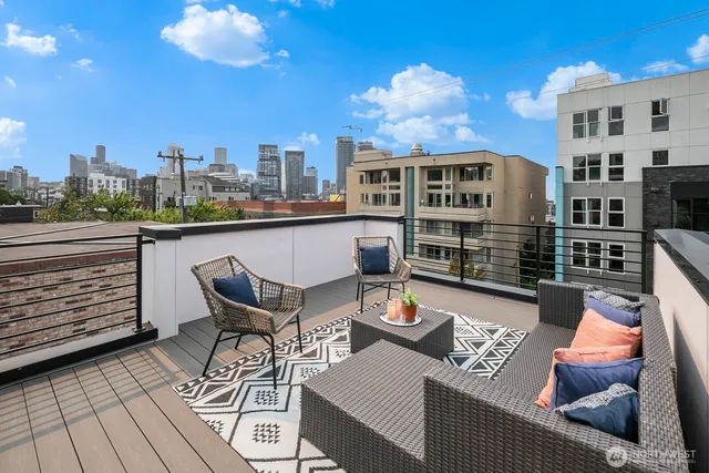 a view of a terrace with furniture and wooden floor