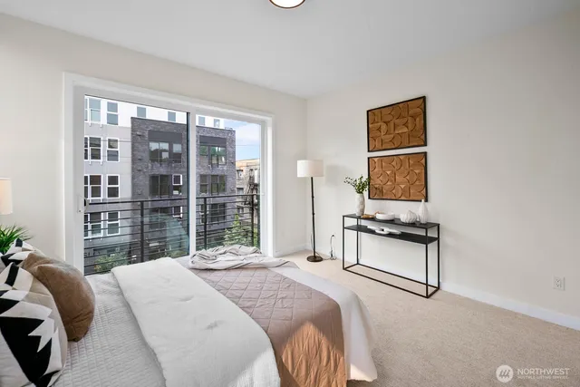 a bedroom with a bed a couch and a window