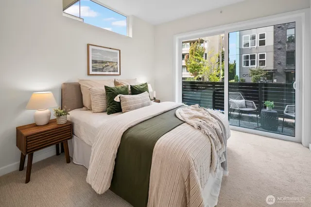 a bedroom with a bed and a lamp next to a window
