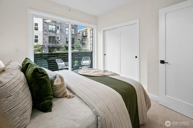 a bedroom with a bed and a large window