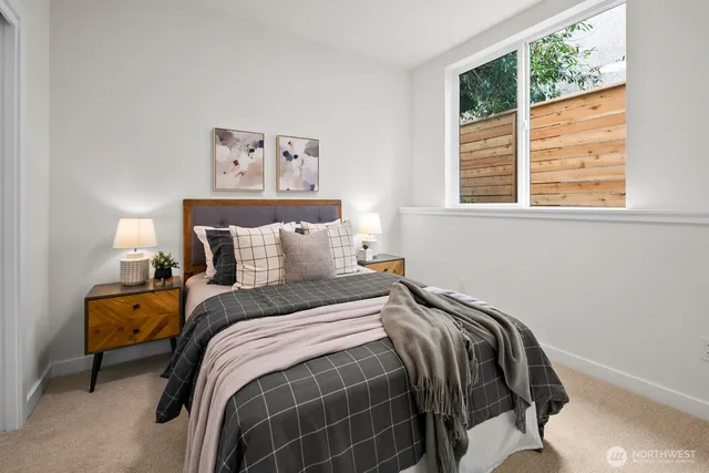 a bed sitting in a bedroom next to a window