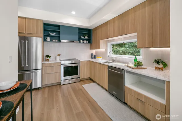 a kitchen with stainless steel appliances a refrigerator sink and cabinets