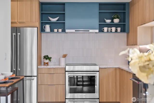 a kitchen with stainless steel appliances a refrigerator and a stove