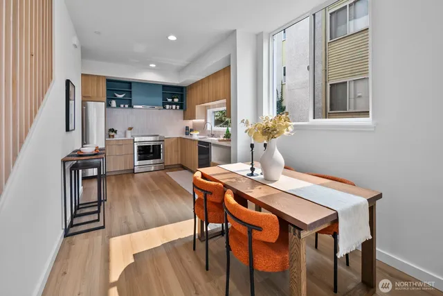 a view of a dining room with furniture and wooden floor
