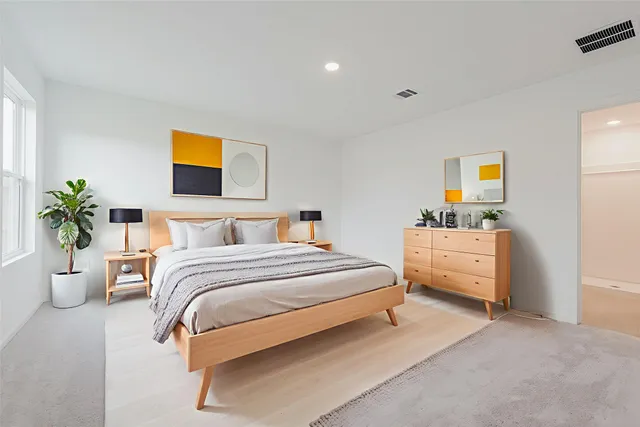 a bedroom with a bed and a couch