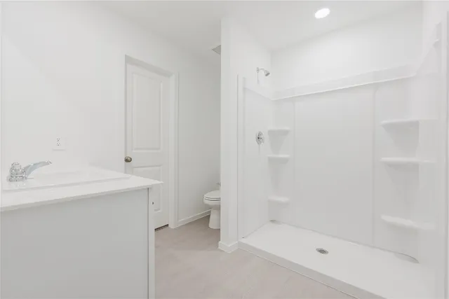 a bathroom with a sink toilet and shower