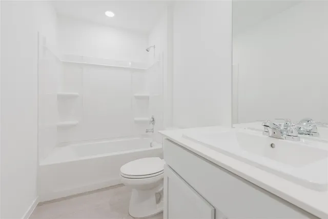 a bathroom with a sink a toilet and bathtub