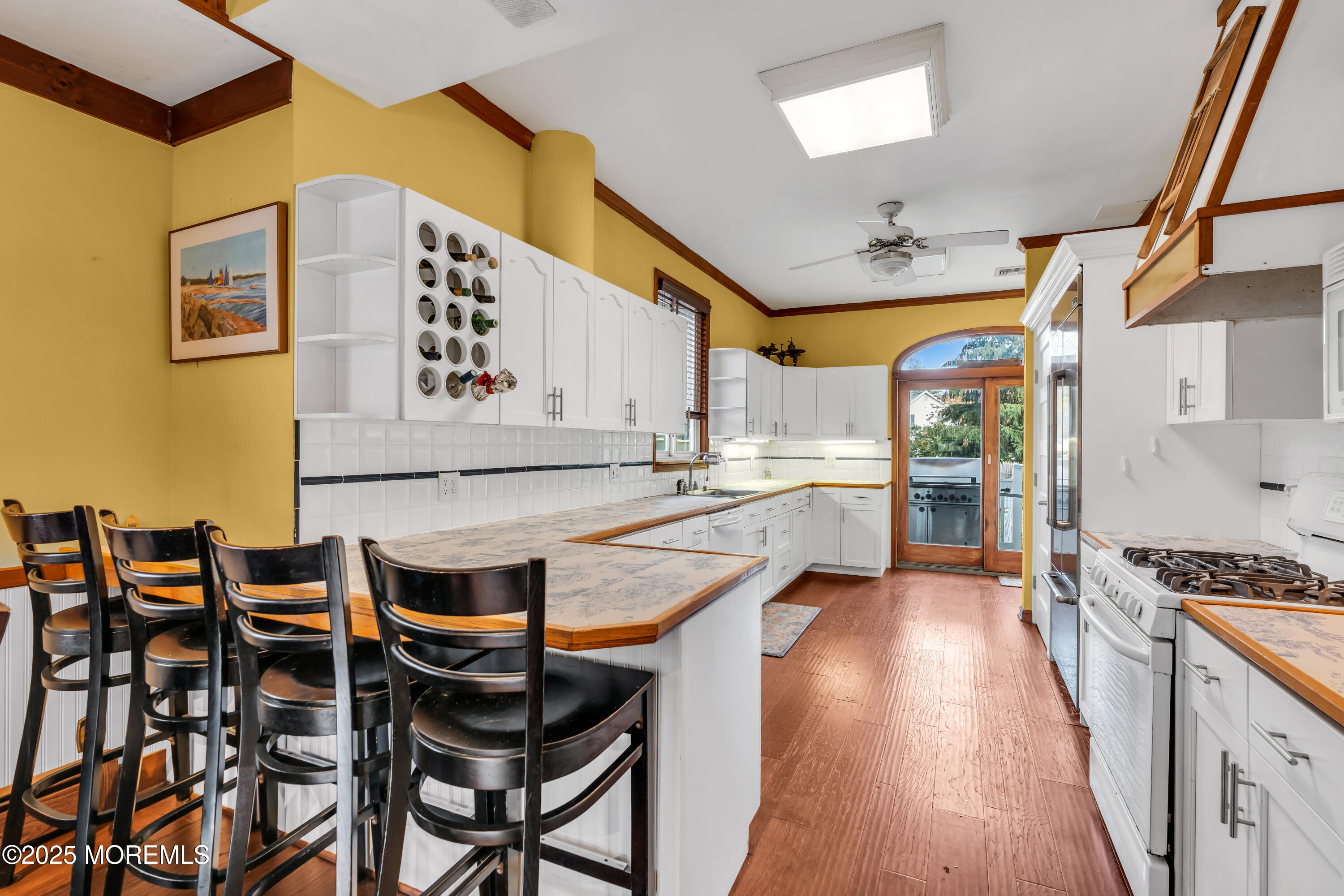 162 East River Road Rumson, NJ 07760 - Photo 20 of 70 a kitchen with stainless steel appliances kitchen island granite countertop a table chairs in it and wooden floors
