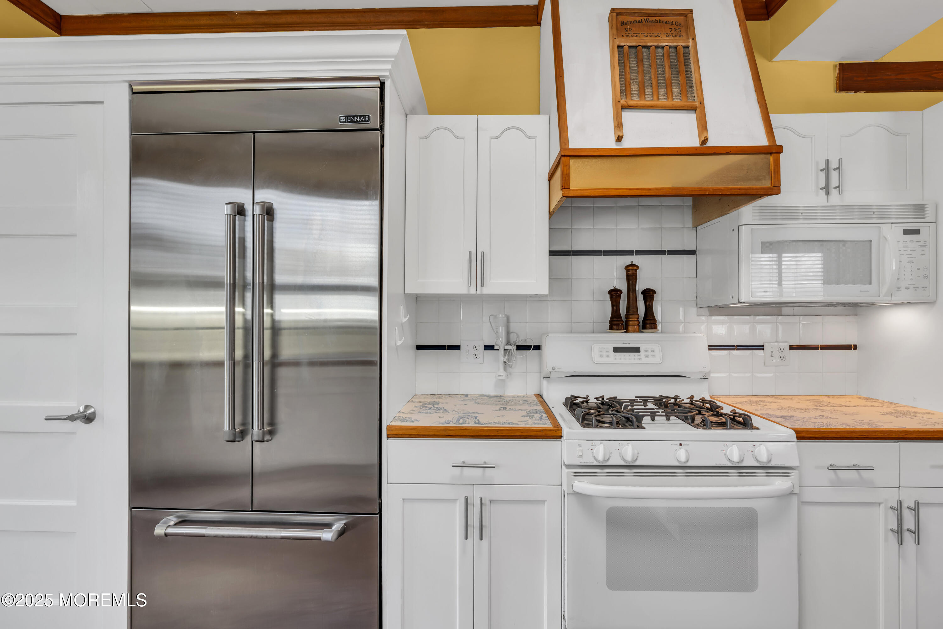 162 East River Road Rumson, NJ 07760 - Photo 25 of 70 a kitchen with a refrigerator and a stove