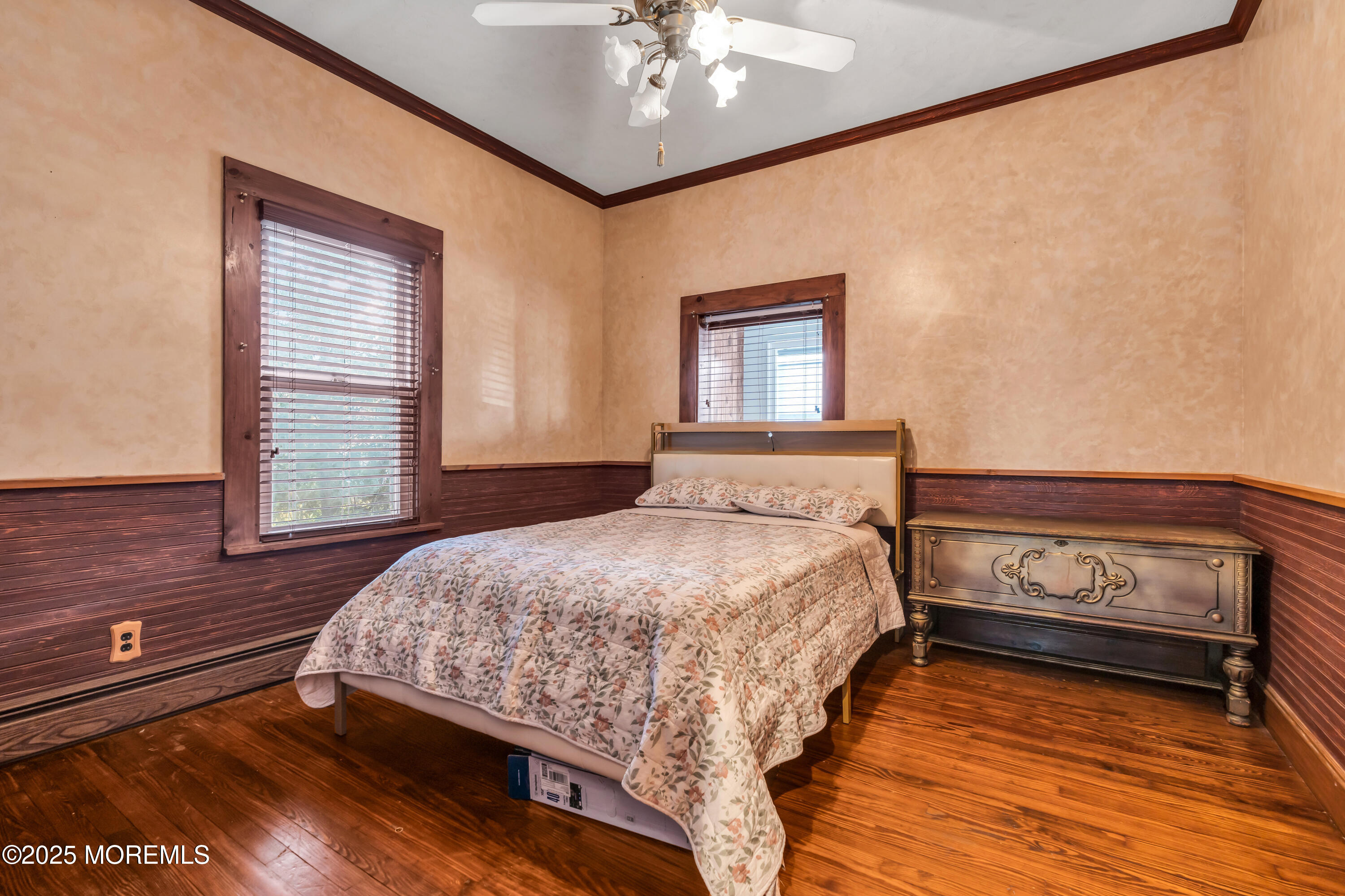 162 East River Road Rumson, NJ 07760 - Photo 29 of 70 a bedroom with a bed and a chandelier