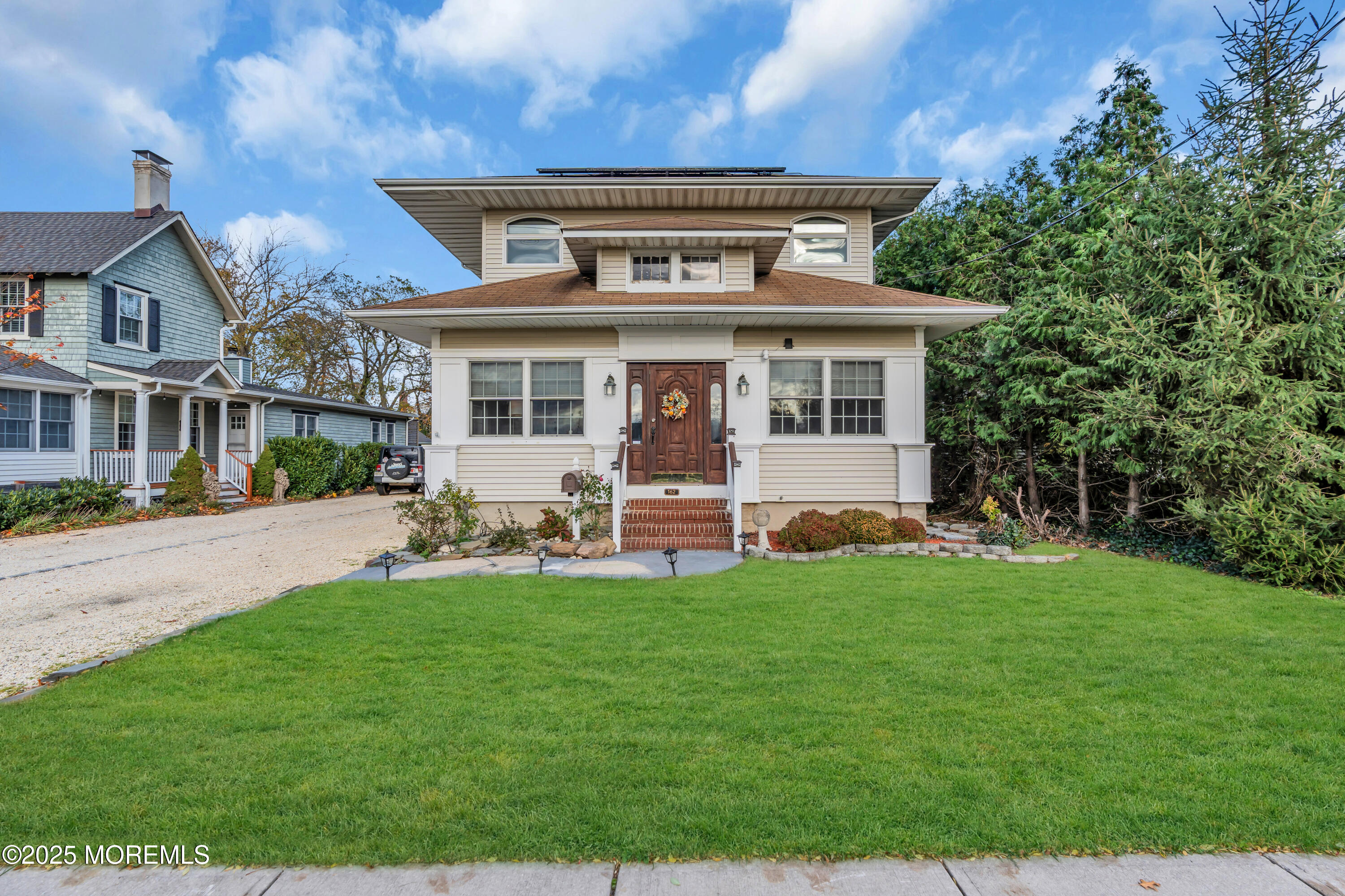 162 East River Road Rumson, NJ 07760 - Photo 3 of 70 a front view of a house with a garden and porch