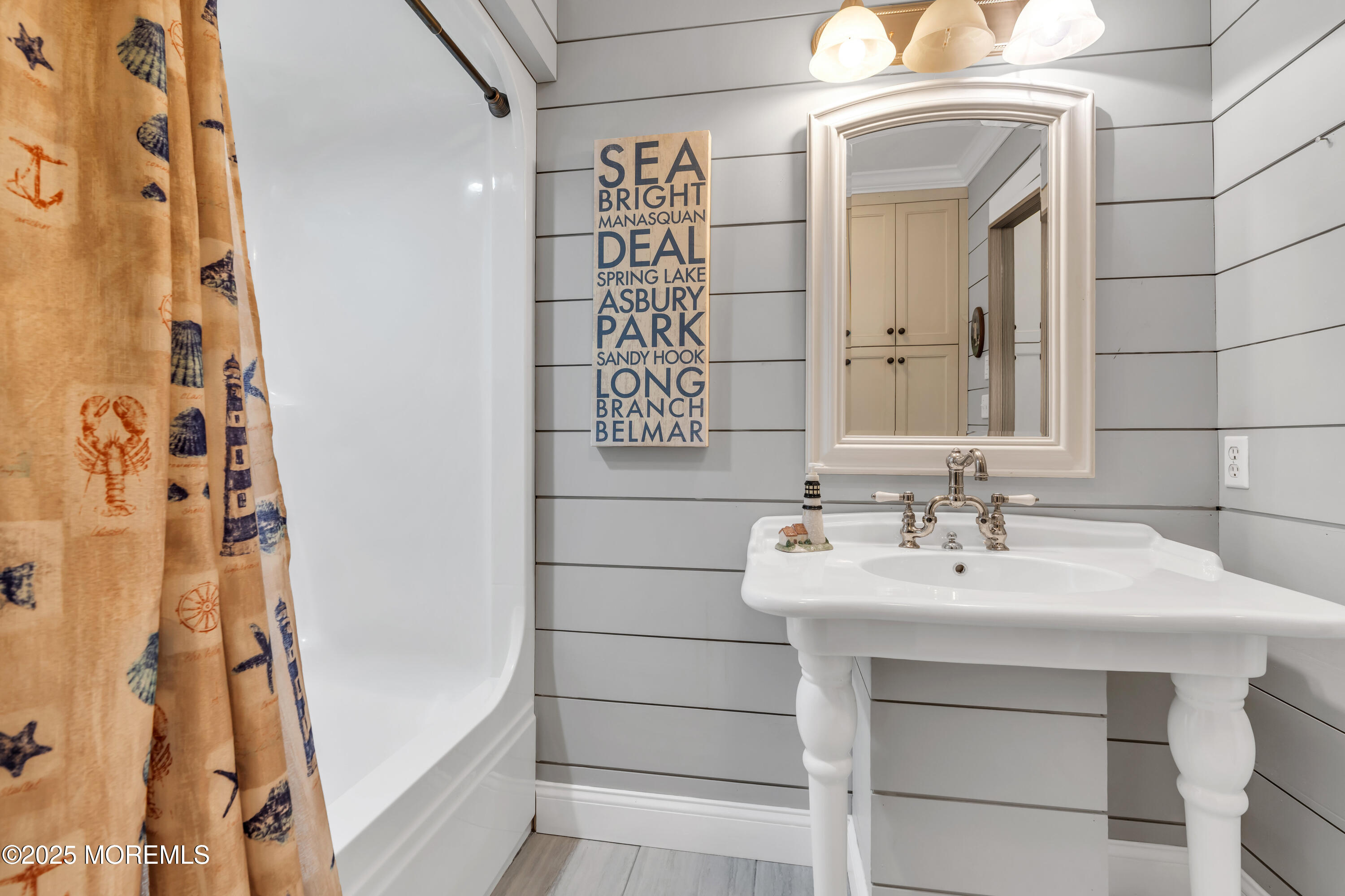 162 East River Road Rumson, NJ 07760 - Photo 31 of 70 a bathroom with a sink and a mirror