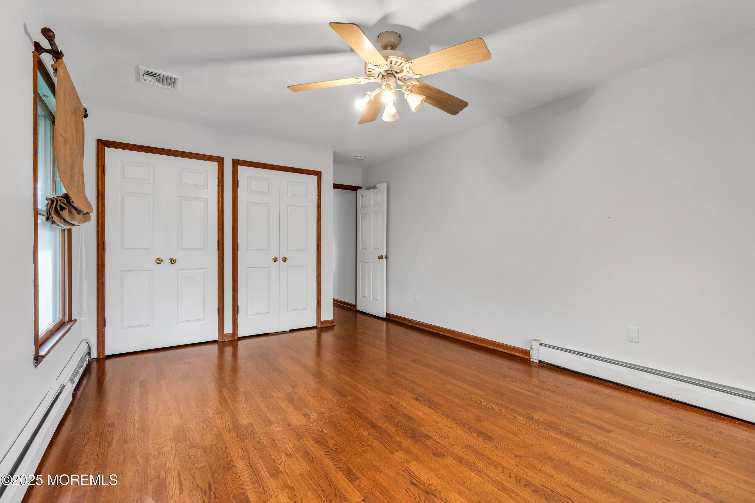 162 East River Road Rumson, NJ 07760 - Photo 34 of 70 an empty room with wooden floor and windows