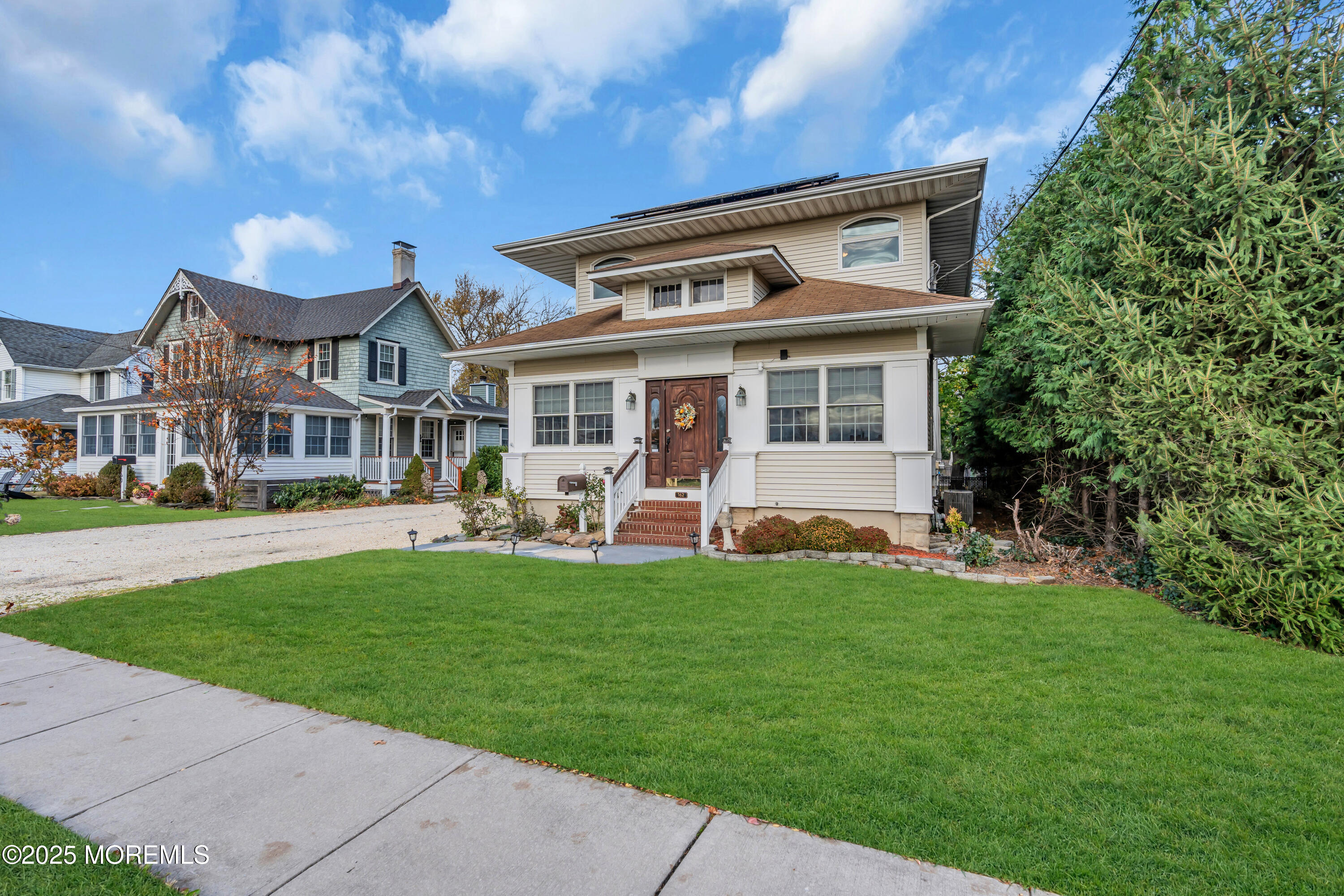 162 East River Road Rumson, NJ 07760 - Photo 47 of 70 a front view of a house with a garden and plants