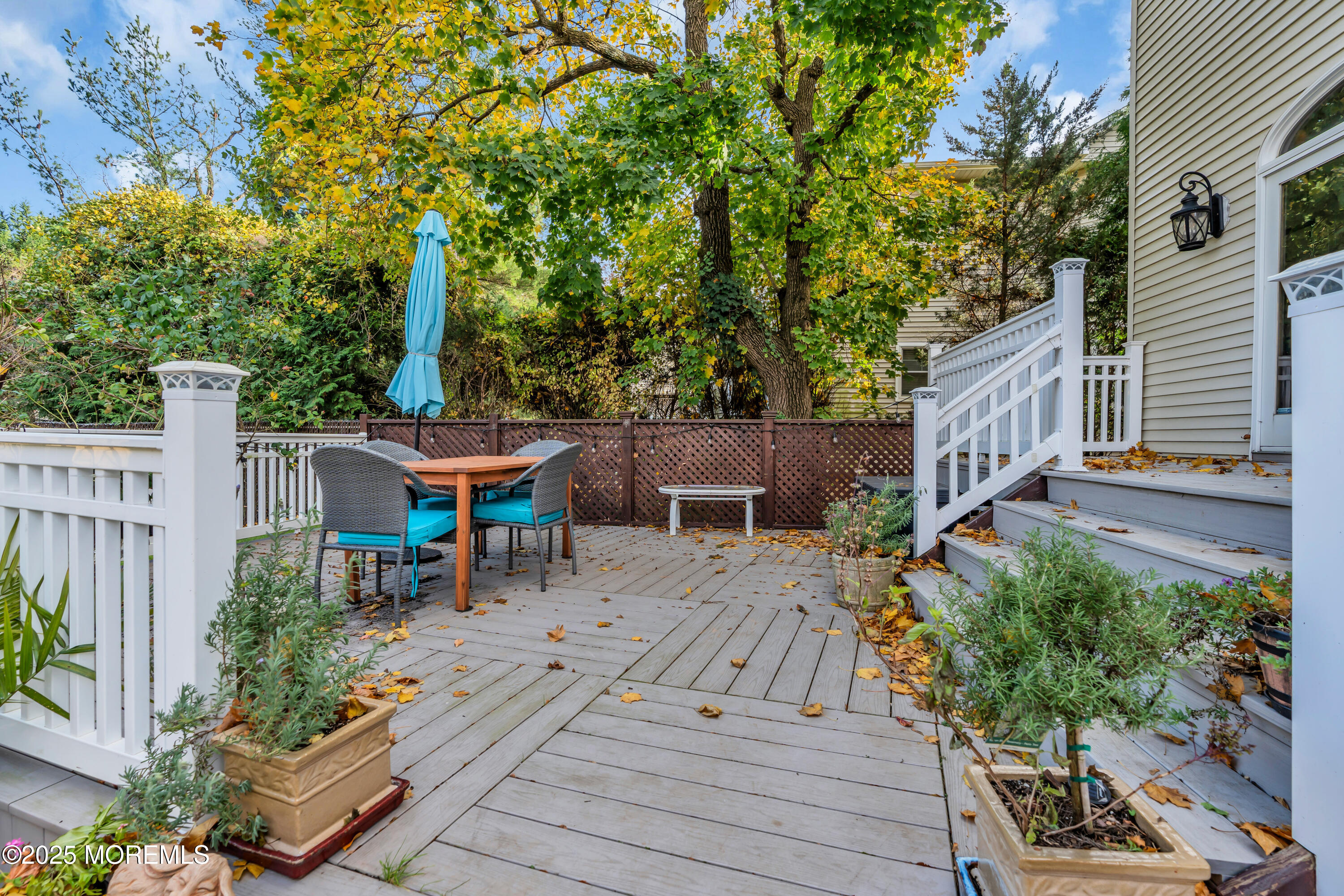 162 East River Road Rumson, NJ 07760 - Photo 50 of 70 a view of a patio with table and chairs potted plants and wooden fence
