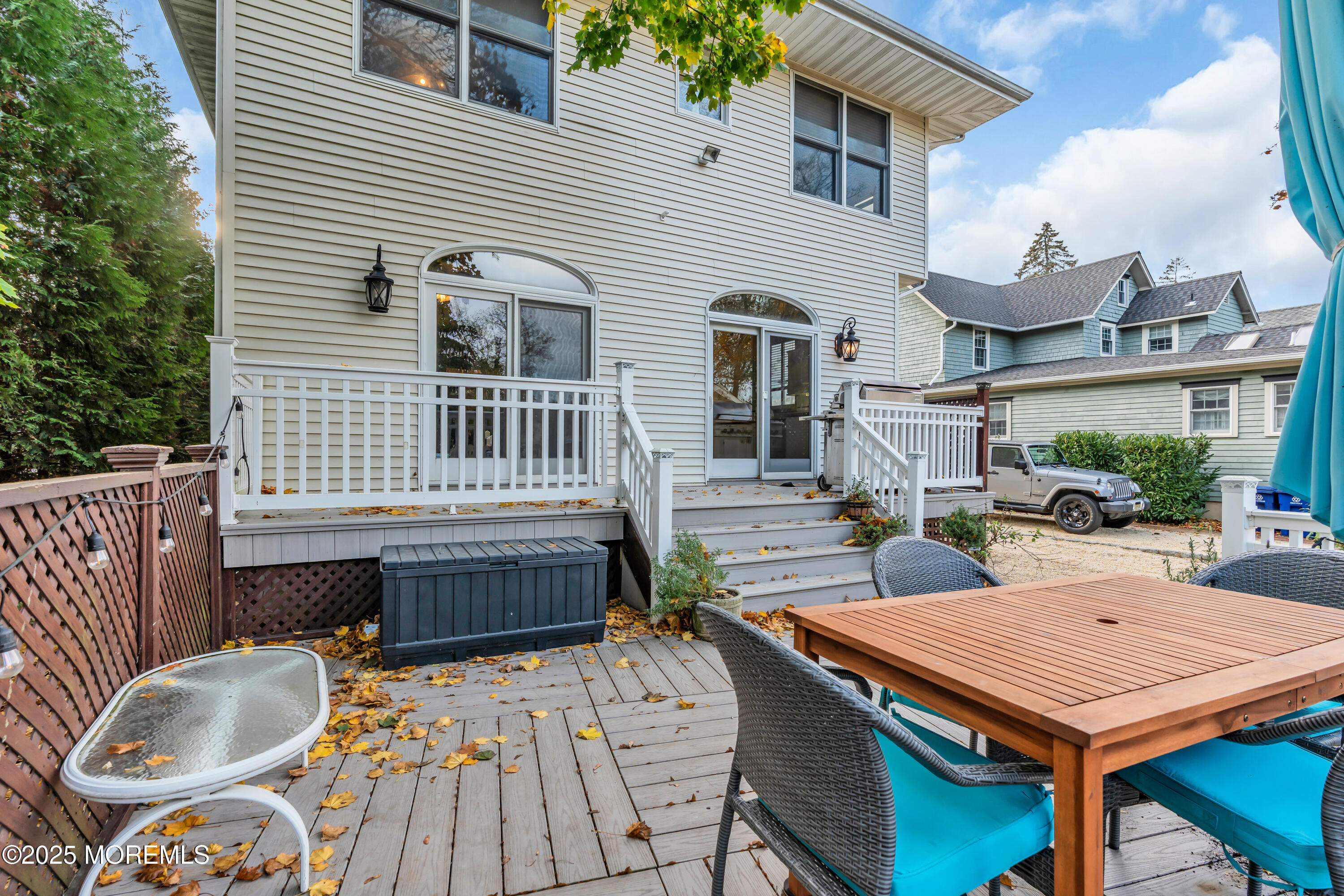 162 East River Road Rumson, NJ 07760 - Photo 54 of 70 a view of a patio with table and chairs with wooden floor and fence