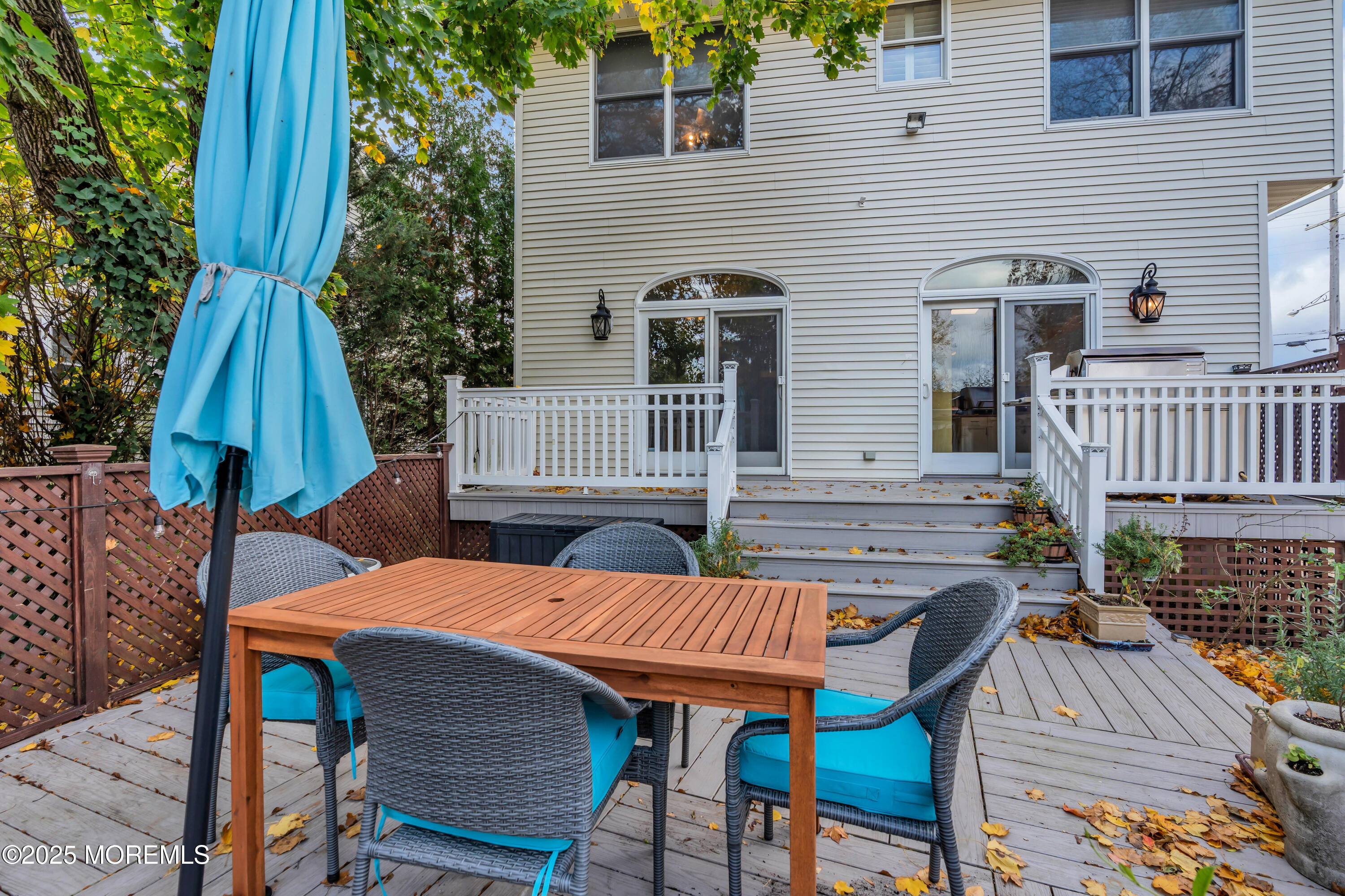 162 East River Road Rumson, NJ 07760 - Photo 55 of 70 a view of a patio with table and chairs with wooden floor and fence