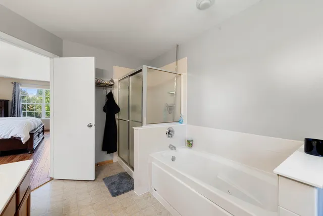 a bathroom with a bathtub and a window