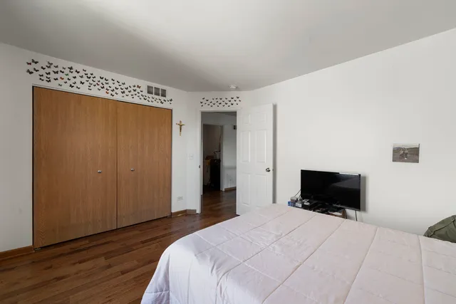 a bedroom with a bed and a television