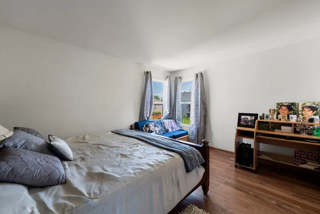 a bedroom with a bed and a large window