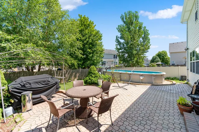 a view of a patio with table and chairs and potted plants